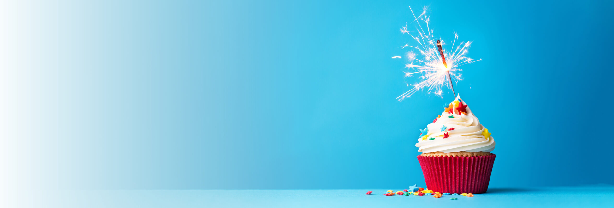 Cupcake with candle to celebrate 110 years in business.